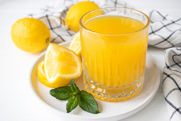 fresh lemon juice with mint in a glass on the table