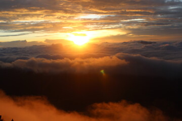 Orange sky the sun is starting to rise and a beautiful sea of ​​clouds
