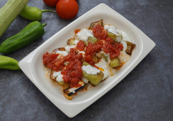 Traditional delicious Turkish food, yoghurt with garlic, fried mixed vegetables (potato, eggplant, roasted pepper), Turkish name; mixed stir-fry vegetables