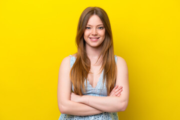 Young caucasian woman isolated on yellow background keeping the arms crossed in frontal position