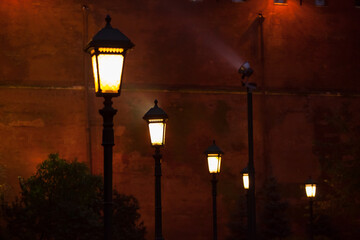 Street lighting lantern on dark Red Kremlin Wall background. Alexander Garden in Moscow at evening....