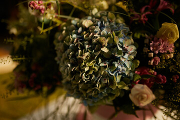 A bouquet of gorgeous festive flowers on a table in the yard. 