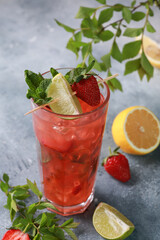 Summer. Drinks and cocktails. Strawberry mojito with ice and mint, lime on a light gray background. Background image, copy space