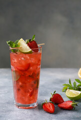 Summer. Drinks and cocktails. Strawberry mojito with ice and mint, lime on a light gray background. Background image, copy space