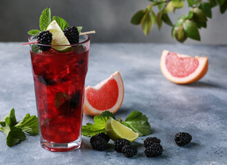 Summer. Drinks and cocktails. Mojito diablo. Beverage with grapefruit, blackberries and currants with ice and fresh mint in a glass on a light background. Summer. Background image, copy space