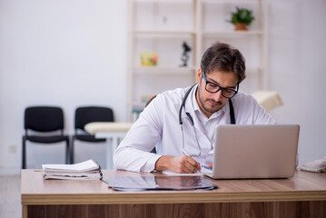 Young male doctor working in the clinic