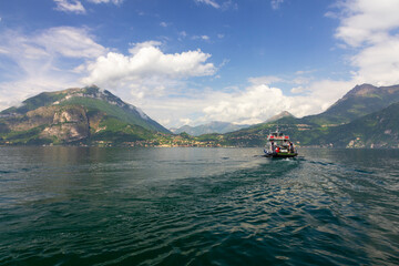 Como lake mountain fjords landscape with tourist cutter, Italy, Lombardy