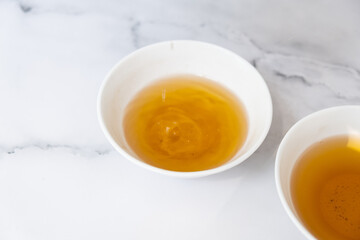 Tea drops fall into a cup. Tea ceremony concept