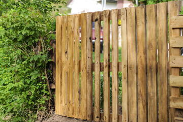 Rustic fence made from old recycled wooden pallets