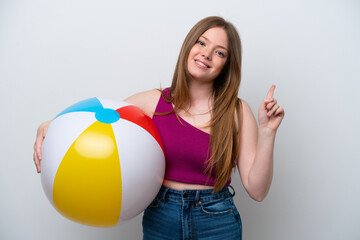 Young caucasian woman holding beach ball isolated on white background showing and lifting a finger in sign of the best