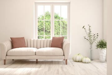 Fototapeta premium White living room with sofa and summer landscape in window. Scandinavian interior design. 3D illustration