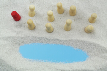 The biblical story - Moses leads the Jews through the desert. People figures with red leader on sand background, copy space for text.