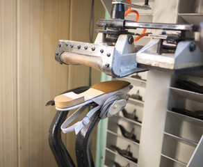 man repairing women's shoes. workflow, indoor shoe repair machine. Restoration of women's shoes, private business.