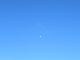 beautiful photo of the moon with plane crossing travel