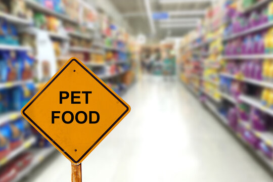 Blur Image Of Pet Food Aisle In Supermarket With Message