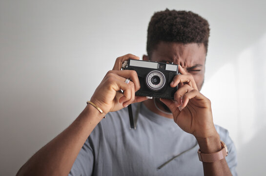 young man takes a picture with a camera