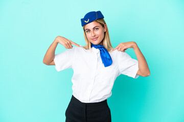 Airplane stewardess Uruguayan woman isolated on blue background proud and self-satisfied
