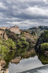 Tajo River with reflection of mountains and buildings