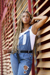 Stylish black woman with Afro braids in city