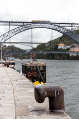 Fototapeta premium Rusty mooring bollard on the Douro river dock in Porto, Portugal