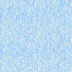 Seamless pattern of white flowers on blue background. Floral background for fashion, wallpaper, print. Lots of daisies in the field. Trendy floral design. Flat simple style for fabrics