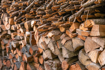 Winter preparation. Stacking Firewood. Pile of firewood loggs. Firewood background. Dry chopped firewood logs in a pile.