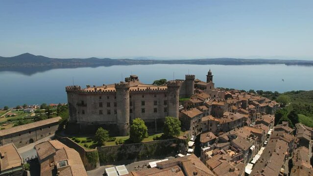 Scenic lake and beautiful medieval town Bracciano. Italy. Aerial cityscape view with impressive castle and lake at background.