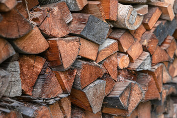 Winter preparation. Stacking Firewood. Pile of firewood loggs. Firewood background. Dry chopped firewood logs in a pile.