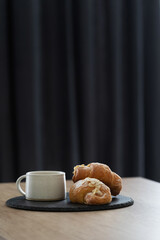 Coffee and fresh croissants on wooden table