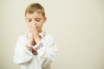 Ukrainian boy prays against the war