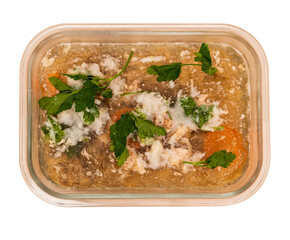 Traditional Russian food for the New Year. Jellied beef, pork, carrots, onions, celery and herbs. Tasty food. The dish is served cold. Isolated on a white background.