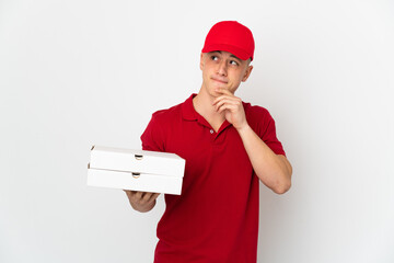 Pizza delivery man with work uniform picking up pizza boxes isolated on white background having...