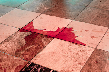 red liquid on the tile floor