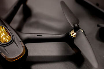 The drone is black on a dark background. soft focus. Closeup. One of the most portable drones in...