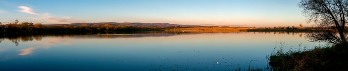 Panorama lake view in sunrise time .Sunrise at the lake