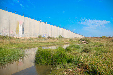 Fototapeta na wymiar landscape, Green Field With Blue Sky, near the Israeli wall. Qalqilya. west bank, Palestinian Territories, Palestine. May 22, 2022