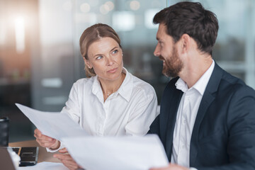 Two business people during work meeting in modern office explaining statistics data to each other 