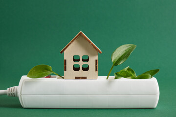 wooden miniature house, green leaf plug, surge protector, eco-friendly electricity for your home