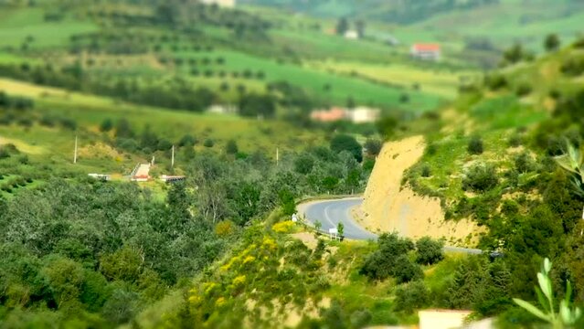 Top view of a mountain road in the springtime in the village. Miniature effect.