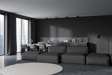 Grey kitchen interior with sofa, eating table and kitchenware, panoramic window
