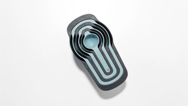 Stop motion concept. Top view of set of plastic measuring cups, kitchen tools.