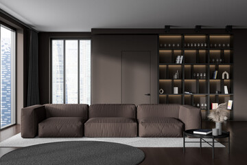 Dark living room interior with sofa and coffee table, shelf and panoramic window