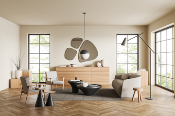 Light living room interior with couch and two chairs, drawer and window