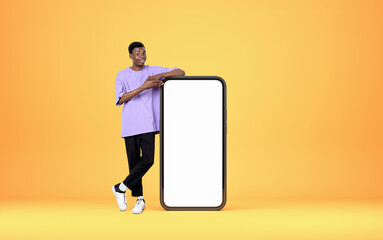 African man hand point at phone, mockup display on bright backgr