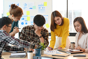 The busy Asian businesspeople looking at document papers on the desk with office suppliers. Business and financial concepts.