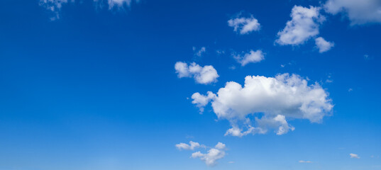 Naklejka na ściany i meble White clouds in blue summer sky panoramic background