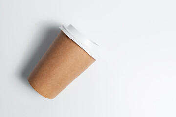 Close-up top view of paper cup for coffee takeaway on white background.