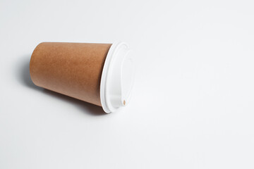 Close-up of paper cup for coffee takeaway on white background.