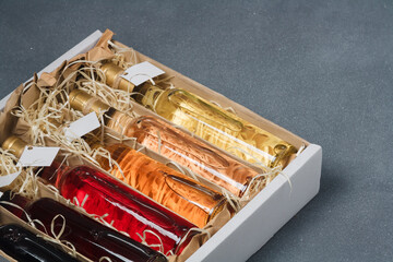 Assortment of 250 ml bottles of red, pink, white wine in box of wooden shavings, no label. Set of...