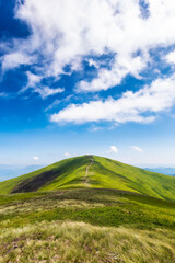path through grassy mountain ridge. wonderful nature scenery of carpathians in dappled light. sunny weather with fluffy clouds on the sky. beautiful landscape of borzhava ridge, ukraine